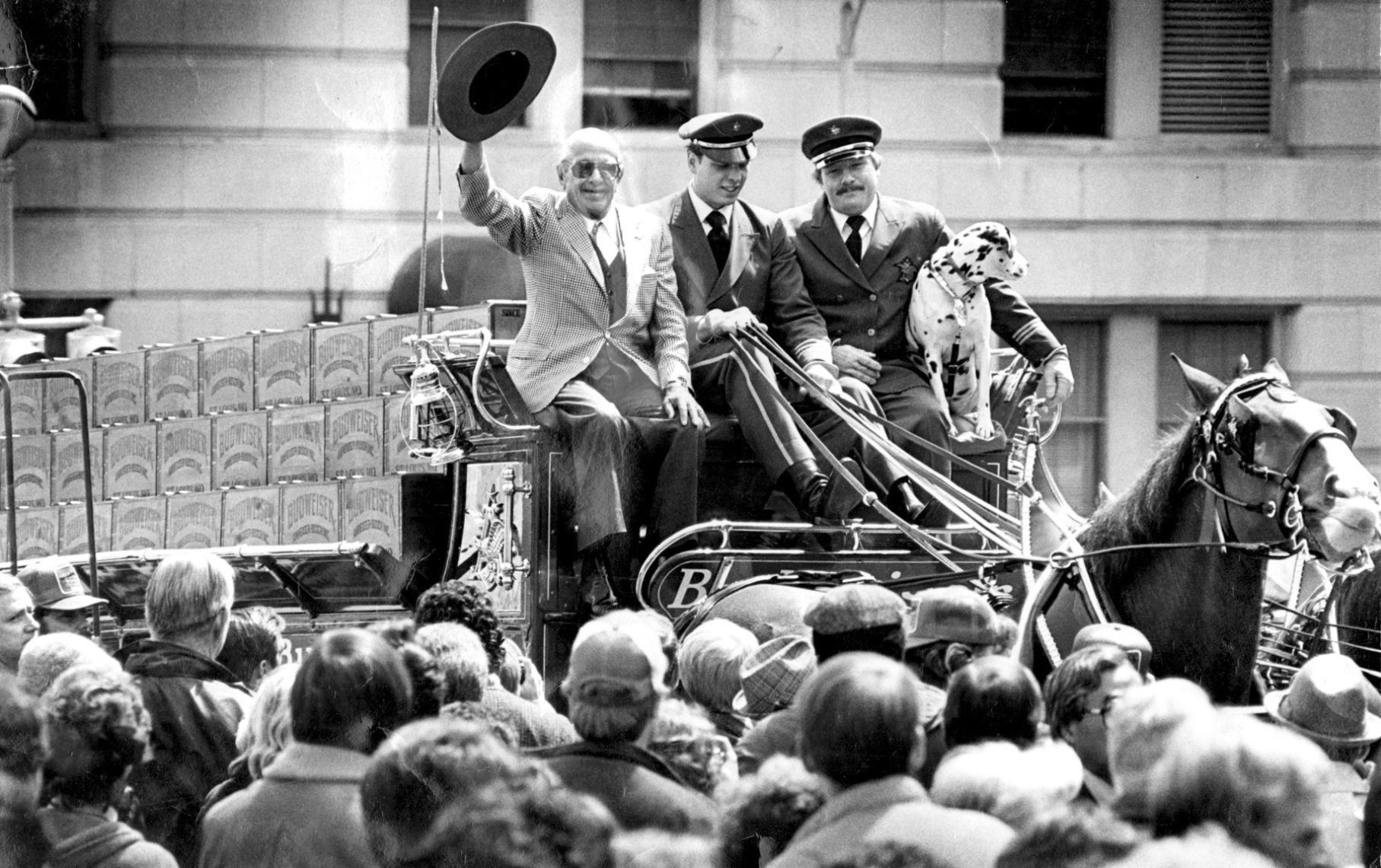 August A. Busch waves from beer wagon in 1983